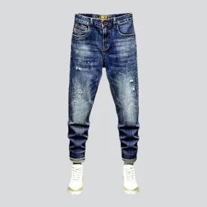 Whiskered men's ripped jeans